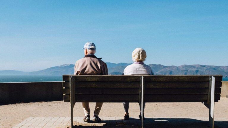 An-older-couple-sitting-on-a-bench-1.jpeg