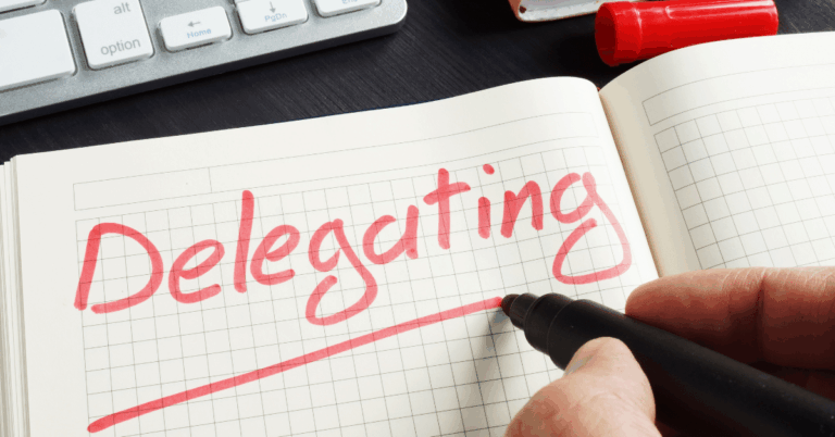 Man-writing-delegating-on-notebook.png