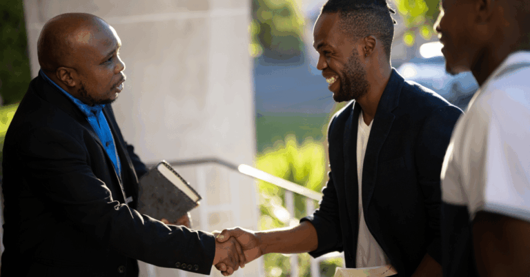 Pastor-greets-and-welcomes-men-to-church-service.png