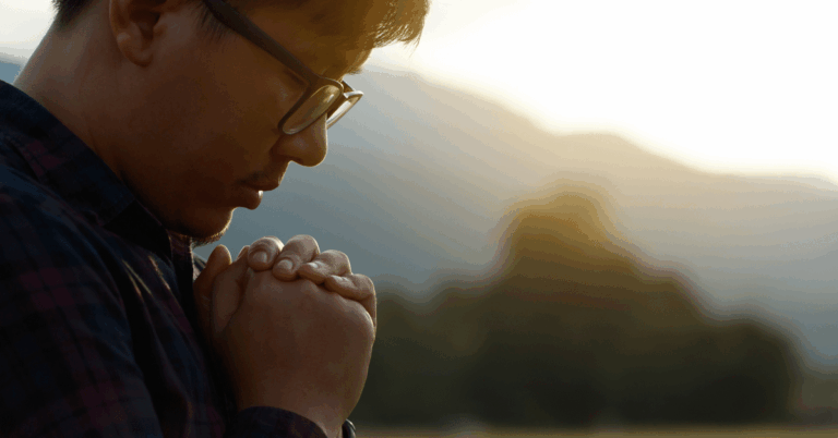 Man-With-Head-Bowed-Praying-Outside.png