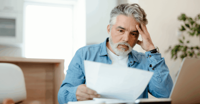 Worried-Man-with-High-Tax-Bill-Invoice.png