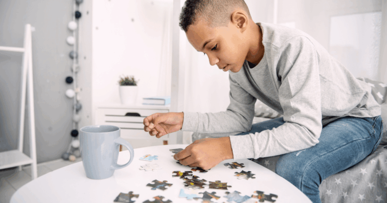 Teenage-Boy-Putting-Together-a-Puzzle.png