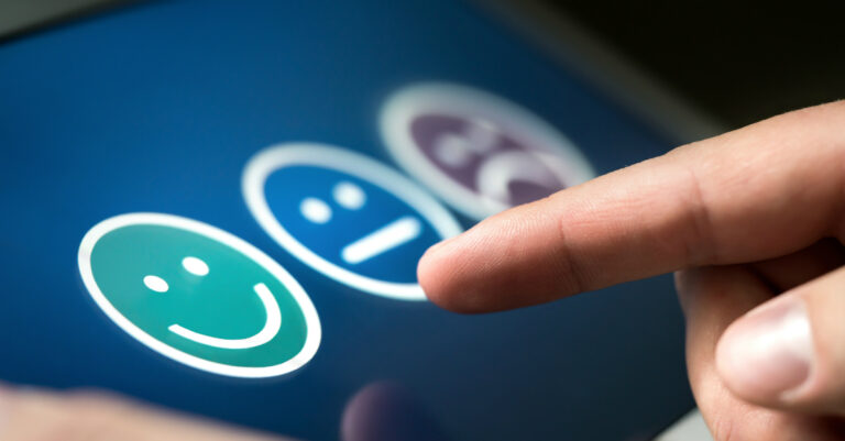 10700-finger-on-ipad-choosing-happy-face-icon-getty.jpg
