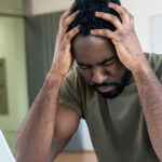 13853-stressed-at-work-man-holding-head-in-hands-ov.jpg