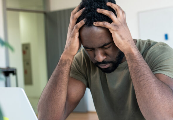 13853-stressed-at-work-man-holding-head-in-hands-ov.jpg