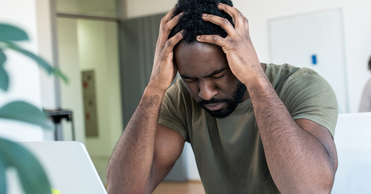 13853-stressed-at-work-man-holding-head-in-hands-ov.jpg