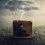16507-scared-man-hiding-in-cardboard-box-in-storm-u.jpg