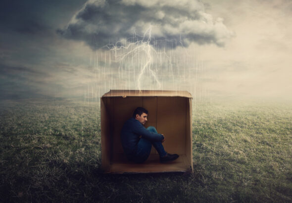 16507-scared-man-hiding-in-cardboard-box-in-storm-u.jpg