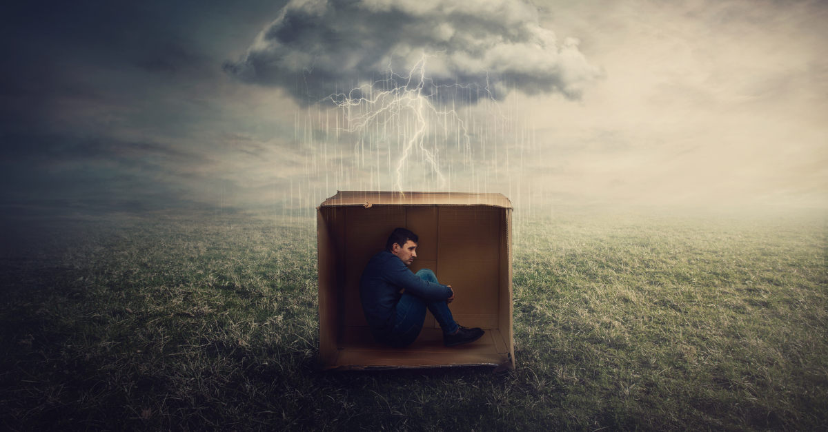 16507-scared-man-hiding-in-cardboard-box-in-storm-u.jpg